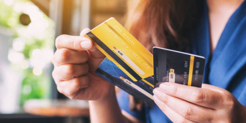 Closeup image of a woman holding and choosing credit card to use